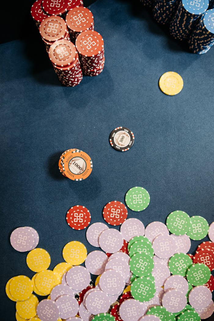 Colorful casino chips scattered and stacked on a gaming table, capturing the essence of gambling excitement.